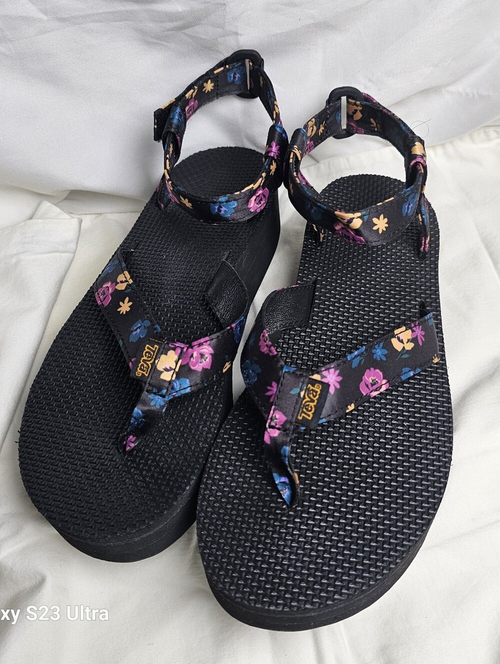 Teva women's platform sandals featuring a black floral pattern